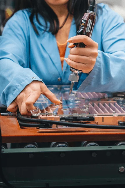 Technician assembling precision GPU coldplate for direct-to-chip liquid cooling.
