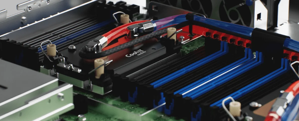 A detailed close-up of a CoolIT Systems coldplate installed on a server motherboard, featuring red and blue fluid lines that represent the intake and return of coolant for efficient chip-level thermal management.