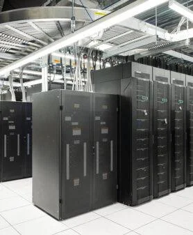 Data centre server racks arranged for high-density computing and liquid cooling integration.