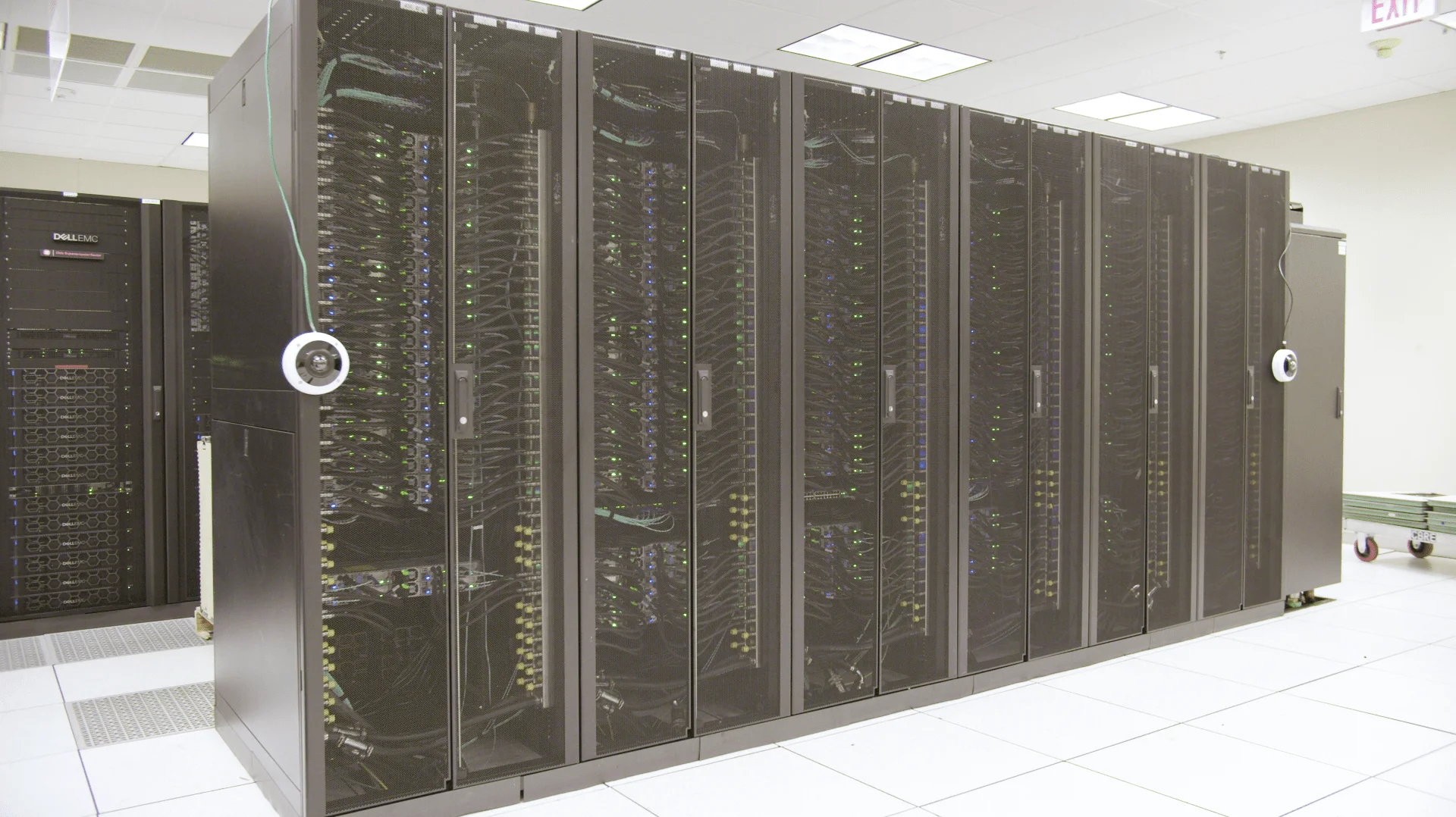 Enterprise server racks with cable management and monitoring systems inside a data centre.