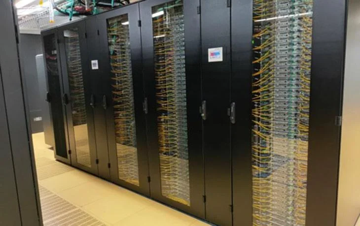 High-density data centre aisle featuring server racks with advanced cooling integration.