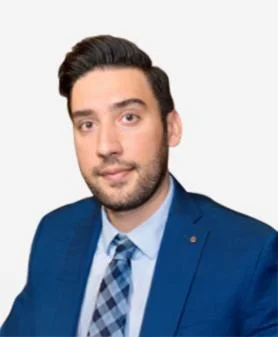A professional headshot of Hamid Rafiei, smiling and wearing a blue suit jacket with a patterned blue tie.