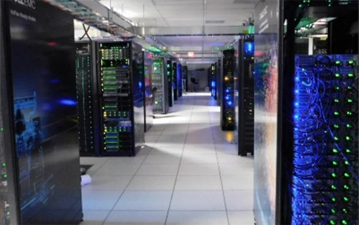 Data centre corridor with rows of server cabinets supporting high-performance computing workloads.