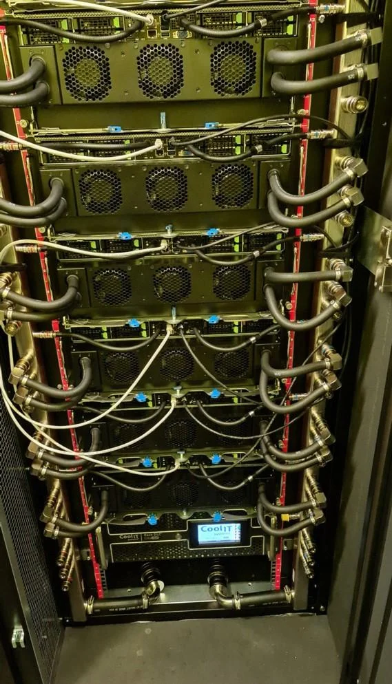 TU Dresden high-performance computing facility featuring large-scale liquid-cooled server racks.