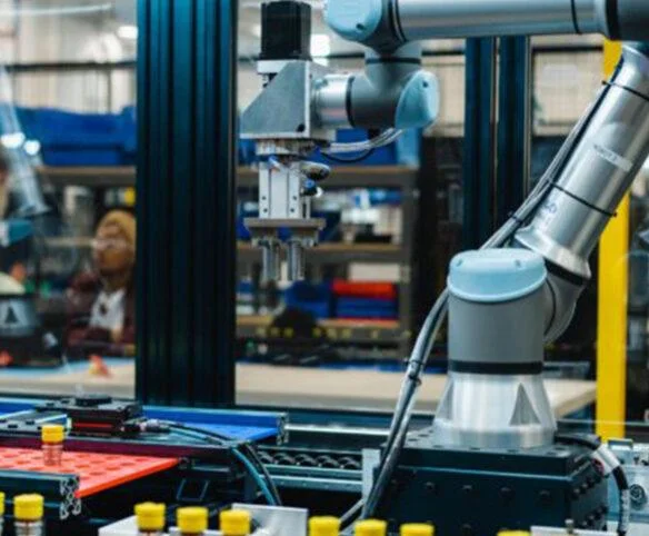 Robotic arm assembling liquid cooling components on an automated manufacturing line