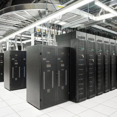 Data centre server racks arranged for high-density computing and liquid cooling integration.