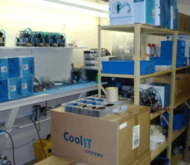 Early CoolIT Systems lab workspace with prototype cooling hardware