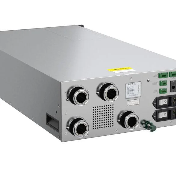 A studio shot showing the rear panel of a silver metal server unit, featuring large circular fluid ports, electrical sockets, and various green and black connection ports.