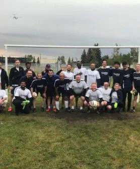 CoolIT Systems team participating in a company soccer match during a team event.