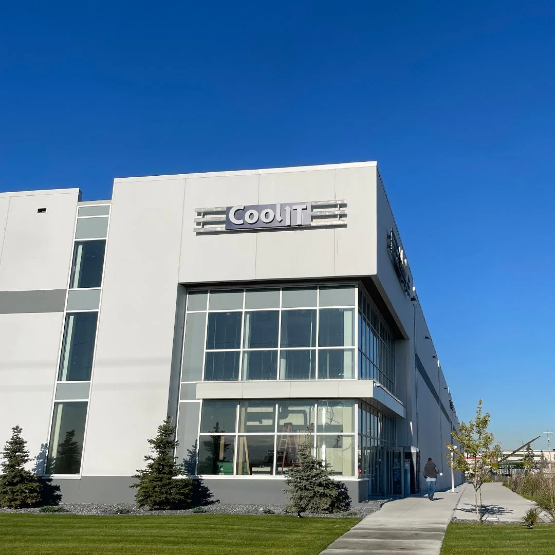 Exterior of CoolIT Systems headquarters building with logo sign and glass facade
