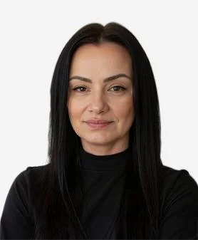 A professional headshot of Evelyn Golba, smiling and wearing a black high-neck top.