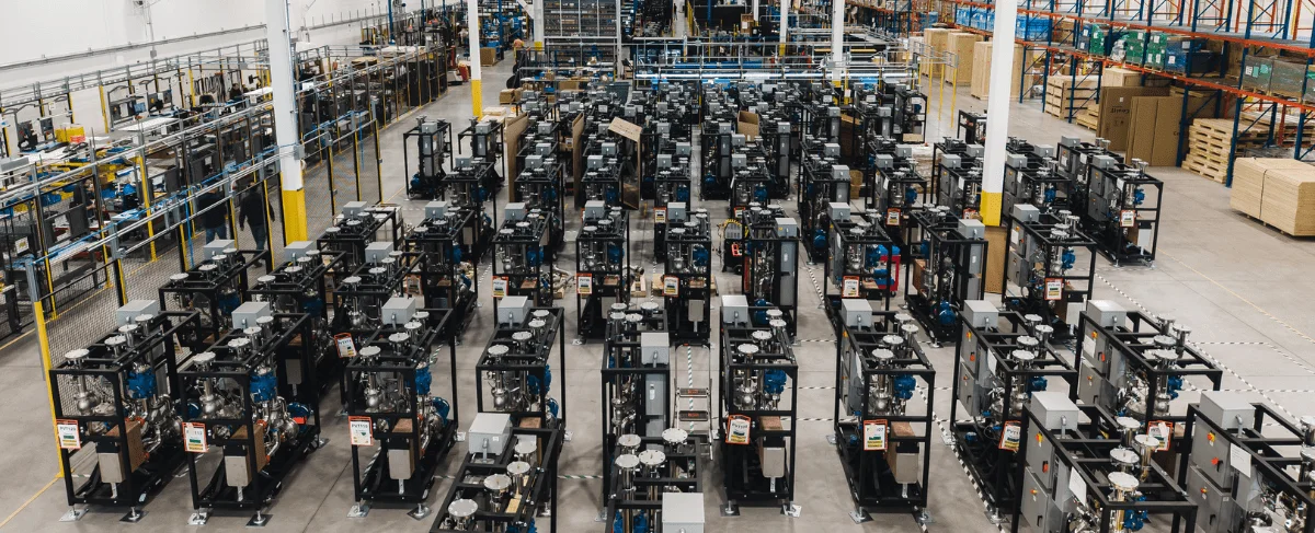 Aerial view of a large warehouse filled with rows of cooling racks and equipment.