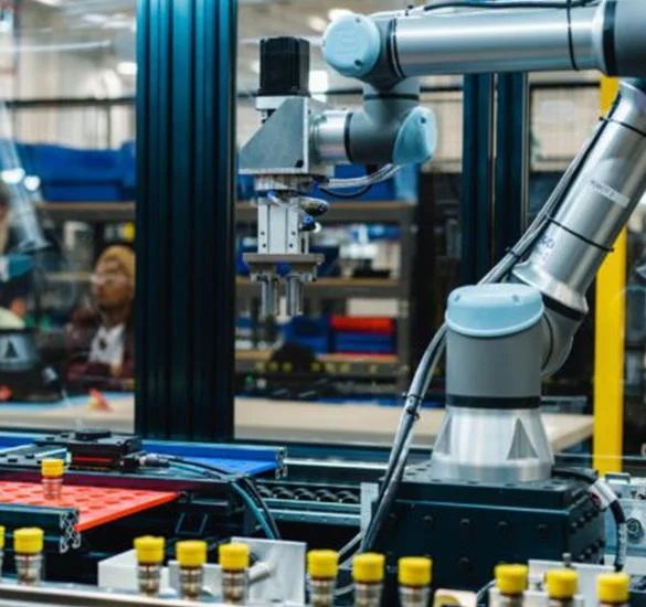 Robotic arm assembling liquid cooling components on an automated manufacturing line