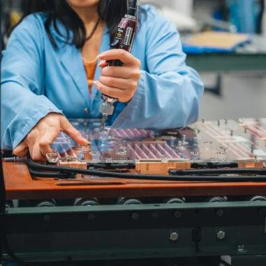 Technician assembling precision GPU coldplate for direct-to-chip liquid cooling.